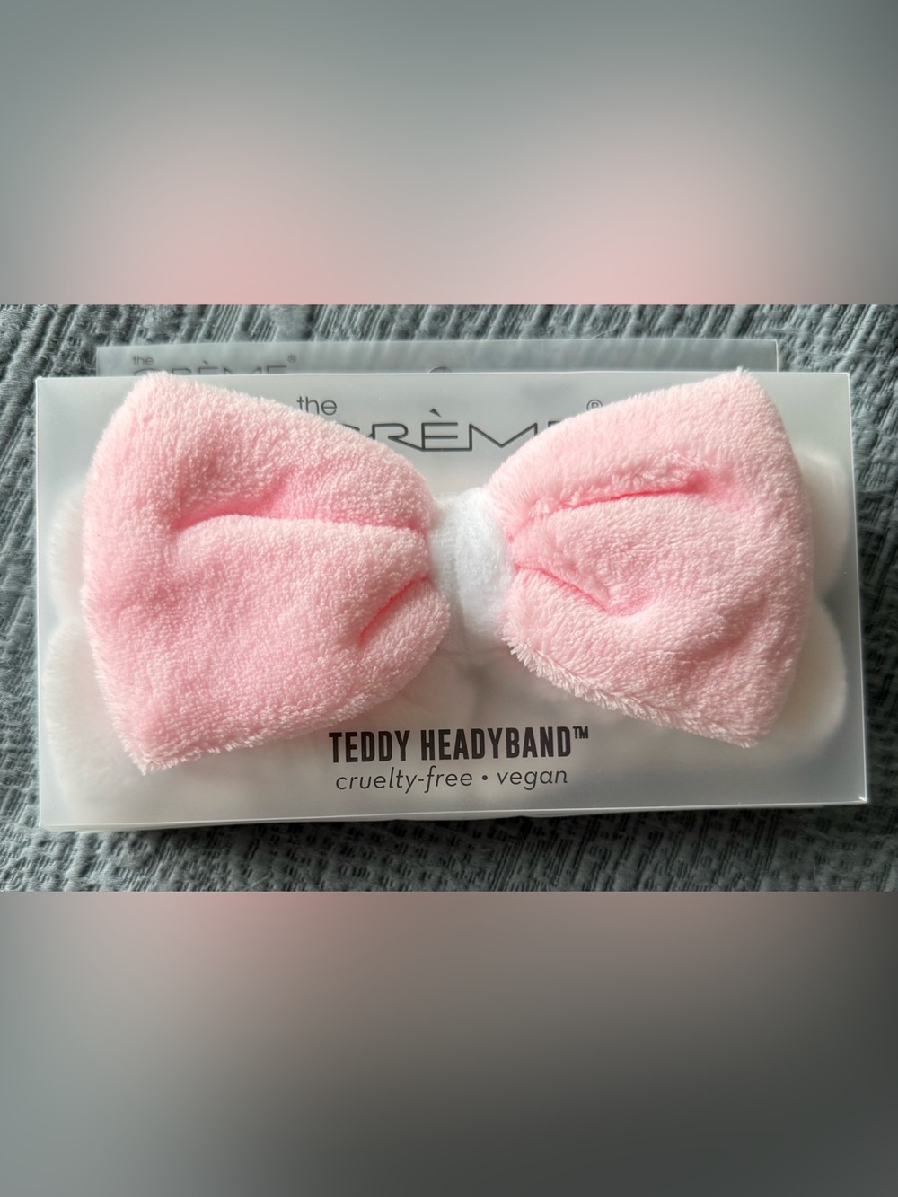 The Crème Shop Teddy Headband in Light Pink and White with a Soft Plush Bow